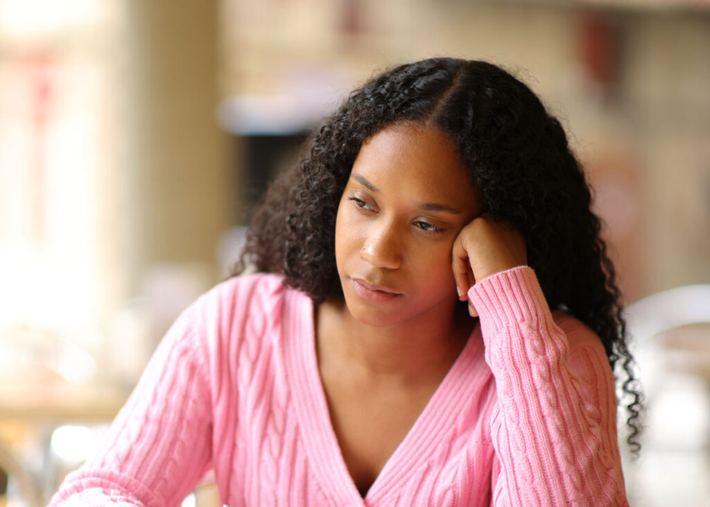 person looking away with a pensive expression,